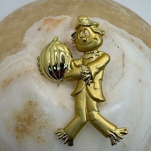 Vintage Danecraft gold-tone scarecrow with pumpkin brooch.